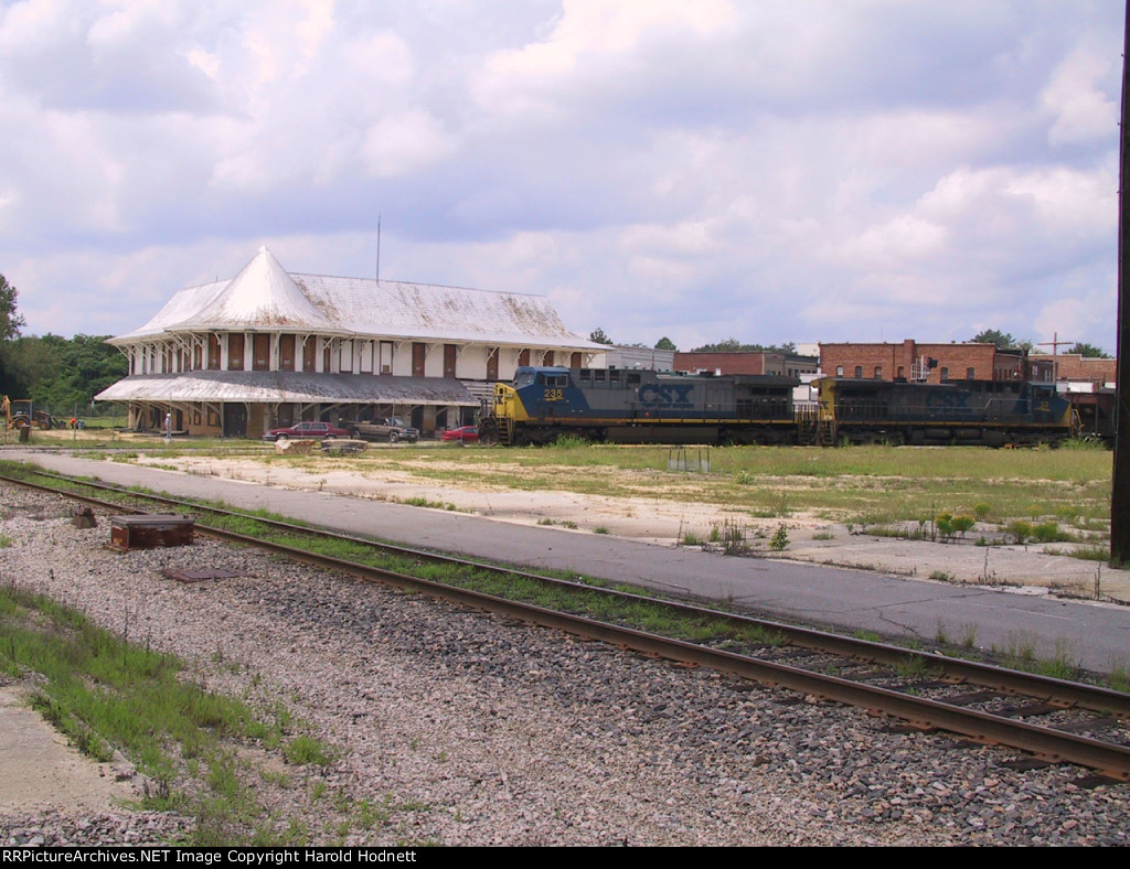 CSX 235 leads a coal train past the unrestored station